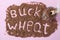 Inscription is made of buckwheat on pink, buckwheat groat in a glass jar, increased demand during the pandemic, Top view