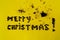 Inscription of merry Christmas,laid out from the beans of coffee.Chocolate background with on yellow texturecolor of the year2019