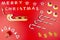 The Inscription Merry Christmas made of wooden letters, lying flat from above, isolated on a red background. Visible candy canes,