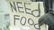 The inscription `Need food` by a poor homeless tramp. Kyiv. Ukraine