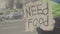 The inscription `Need food` by a poor homeless tramp. Kyiv. Ukraine