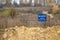 The inscription `NO ENTRY disease prevention area` on a blue plate on an iron