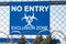 The inscription `NO ENTRY exclusion zone` and biohazard caution sign