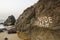 Inscription nude beach on a rock on the background of a sandy beach and the sea