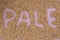 The inscription of pale with malt grains on a lilac textile back