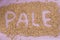 The inscription of pale with malt grains on a lilac textile back