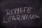 The inscription remote learning on the school blackboard. White letters on a black background in the classroom