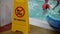 The inscription in Russian do not dive. A yellow sign stands near the pool with a warning inscription against the