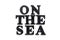 The inscription ON THE SEA. ON THE SEA in black bulk letters on a white background. Photo of the lettering, close-up