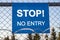 The inscription `STOP! No entry` on a blue plate
