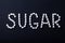 Inscription sugar written from a piece of sugar