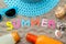 Inscription summer from paper of multi-colored letters and seashells and summer accessories on the sea sand. Summer. relaxation. v