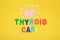 inscription thyroid care and thyroid gland from pink felt on a yellow background nutrition for thyroid diseases