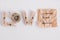 Inscription word love made of wooden clothespins, rope and brown paper sticker on white background. View from above. Place for