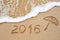 Inscription of the year 2016 written in the wet yellow beach sa