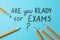 Inscription Are you ready for exams and pencils on blue background
