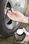 Insert the tip into the tire valve and pump the car wheel with a portable compressor at 12V