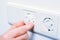 Inserting Baby Safety Plugs Into Wall Socket To Prevent Danger At Home