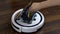 Inserts a new filter into the vacuum cleaner robot.. Automatic white round vacuum cleaner