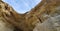 Inside a cavernous entrance on the side of the cliffs looking up