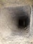 Inside of chimney whose walls are covered with soot and tar