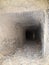 Inside chimney whose walls are covered with soot and tar