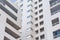 Inside corner of a multi-story residential building, close view of windows and balconies