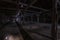 Inside dark abandoned ruined wooden decaying hangar with rotting columns