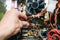 Inside details of the old personal computer. Cooler, motherboard, wires and video card in the dust. Man is holding cables in his