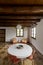 inside a dining room of a rustic mountain cottage, Nobody inside, just a round white table and four chairs