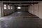 The inside of an empty farm building with white walls and black beams