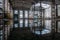 Inside of flooded dirty abandoned ruined industrial building with water reflection