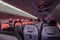 Inside flying passenger aircraft during sunrise with red light s