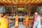 Inside Indosan Nippon Japanese Temple, Lord Buddha statue in the center with wall painted and wooden ceiling with Indian people.