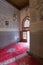 Inside interior of Carpet shop with colourful moroccan rugs and berber carpets on display in a souk market in the centre of medina