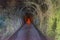 Inside a long brick lined tunnel with algae on the walls