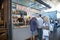 Inside market hall showing food court area with customers looking at frozen yoghurt vendor stand