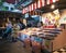 Inside market hall showing food court area with sweet confectionary candy stall