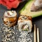 Inside-out Sushi roll with eel decorated with sesame seeds. Sushi Set. Classic Japanese food. Oriental cuisine. Close up