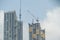 Inside place for many tall buildings under construction and cranes under a blue sky