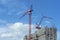 Inside place for many tall buildings under construction and cranes under a blue sky