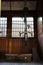 Inside of a rustic room with a bike suspended in front of a plate glass window