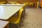 Inside a school classroom of a school with small yellow chairs a