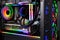 Inside view black high end custom colorful illuminated bright rainbow RGB LED gaming pc. Computer power hardware and technology