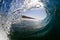 Inside view of a breaking wave on a tropical beach under a blue sky