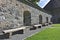 Inside view of the sunlit wall of Castle Hohenwerfen, Austria with shaded alcoves and rough wooden benches