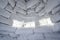 Inside view of a wall of snow bricks and a window made of ice in an igloo, a traditional shelter from the cold of the northern