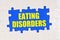 Inside the white puzzles on a blue background it is written - EATING DISORDERS