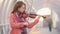 Insipired young woman playing violin on the overhead passage