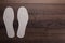 Insoles for shoes on wooden background